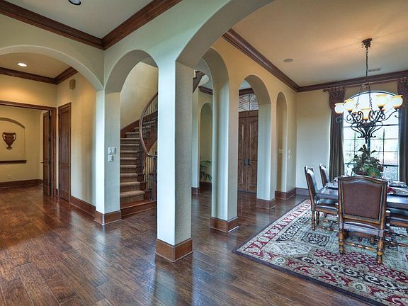 The spacious dining room is nestled within arches.  Stereo speakers give you the opportunity to entertain in style.  The 6.25" hand-scraped style wood floors flow through the foyer the living room, dining room, and master.