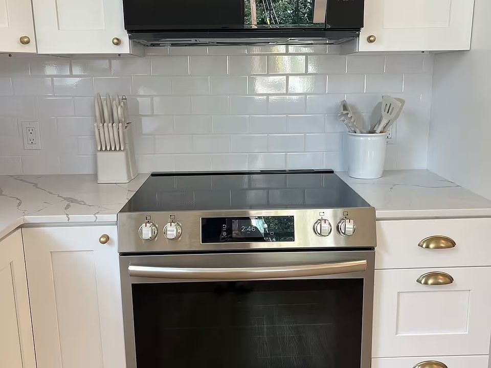 Full size glass cooktop range and over the range microwave.