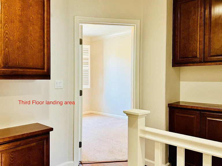 Third floor landing area with storage space