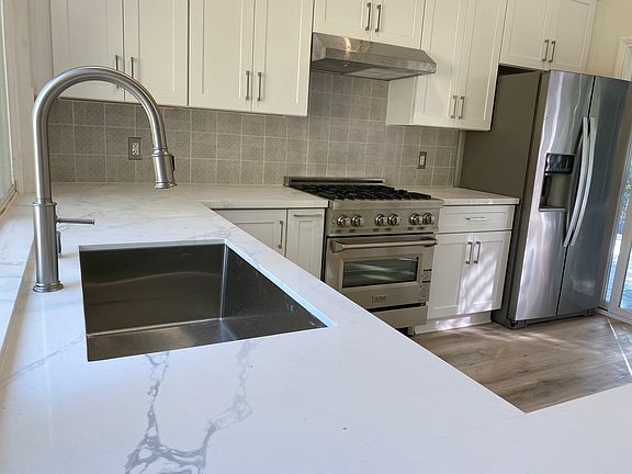 Top-of-the-line gas range and sleek cabinetry _ perfect for cooking and hosting.