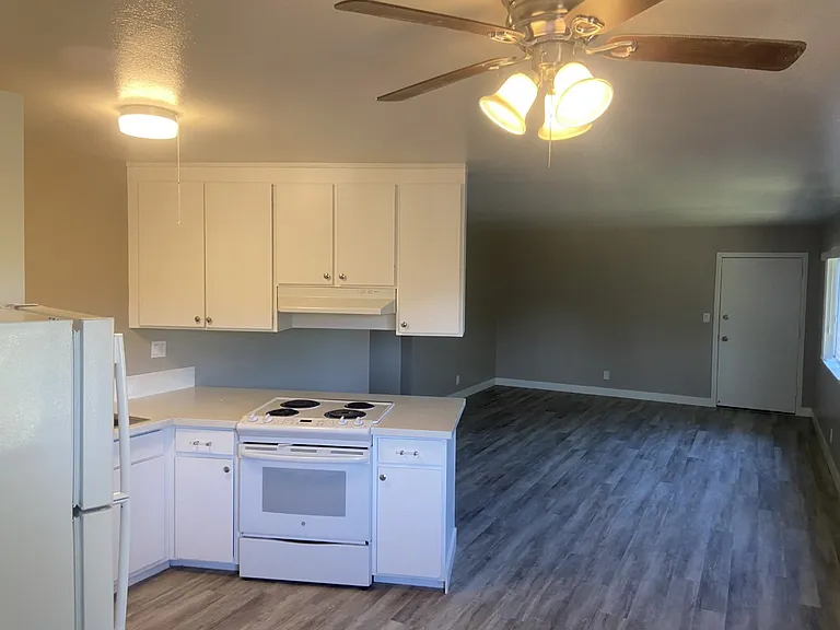 Cook with ease in your all-electric kitchen featuring full-size appliances, granite countertops, and plenty of cabinet space. Natural light pours into the living room, and the eat-in kitchen includes a stylish ceiling fan.