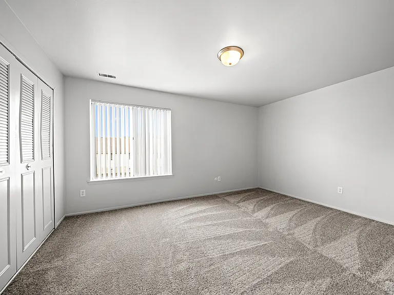 Spacious bedroom with ample storage space at Knottingham Apartments in Clinton Township, MI.