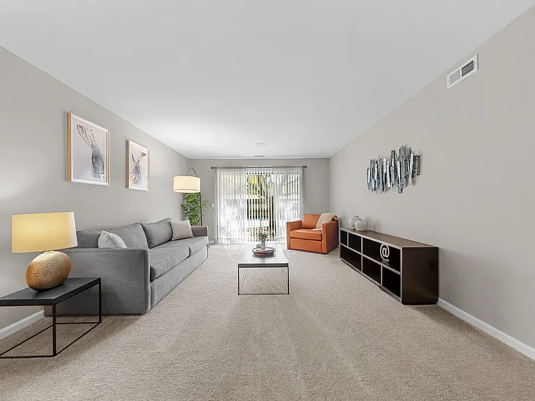 Spacious Living Room with Sliding Glass Door at Lakeside Village Apartments Clinton Township MI