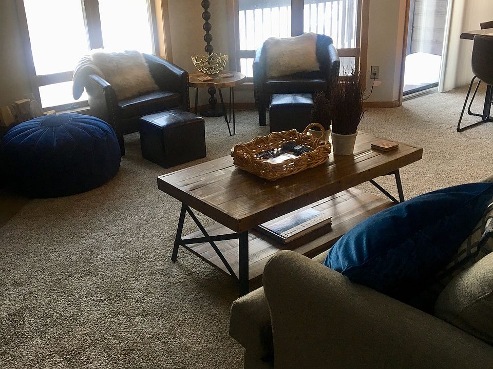 Stylish living area with full size pull out couch and comfy chairs