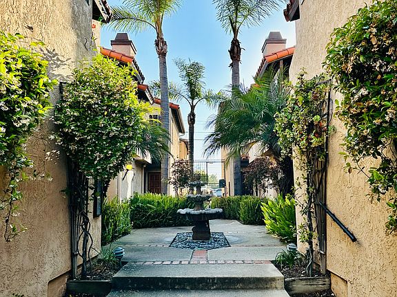 Interior of the gated complex (punch pad enabled) with fountain in center. Landscaping is handled by HOA.