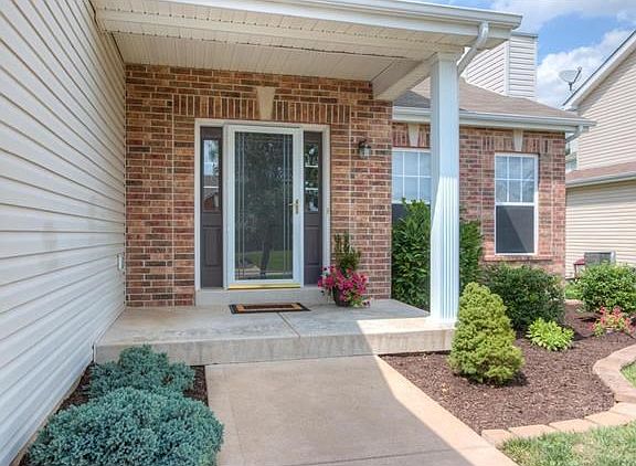 Covered front porch and lovely landscaping greet your guests!