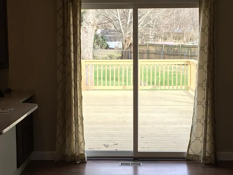 New sliding doors reveal deck and huge yard