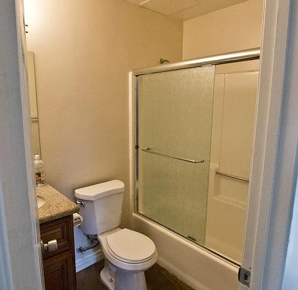 This full bath is downstairs. It has a newer vanity and sink and upgraded rainglass shower doors.