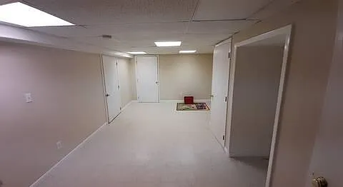 the basement; the door on the left leads to a large unfinished storage space.