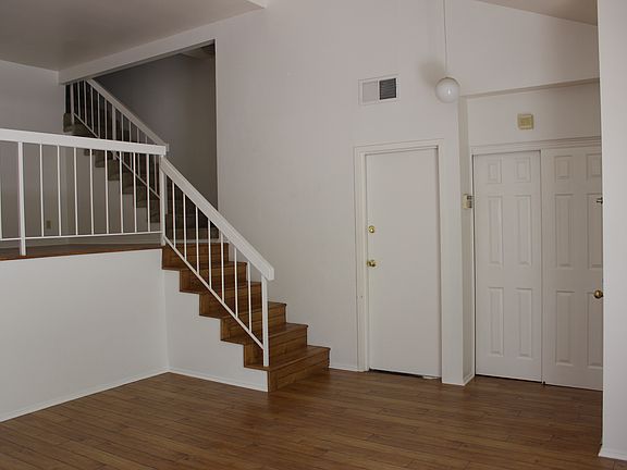 stairs from living room up to dining room, kitchen and den