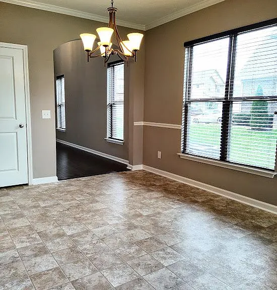 The kitchen features a spacious eating area and brand new flooring.