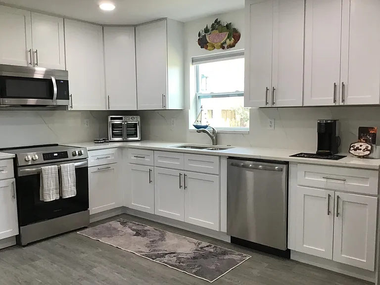 Thoughtfully designed with ample cabinetry, new dishes, glasses, pots and pans, prep space, and stainless steel appliances make daily living easy.