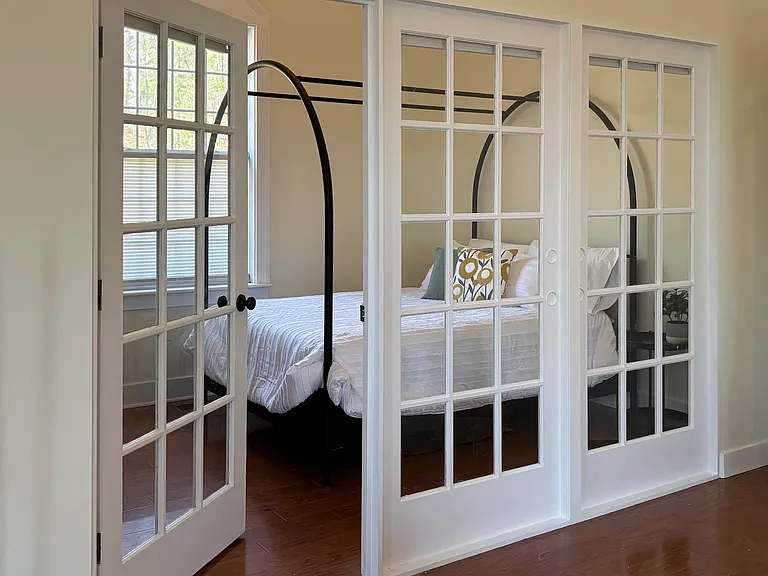 French Doors to bedroom maintain sense of open space.
6' closet with hanging and drawer storage