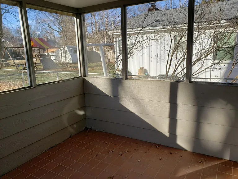 Screened in porch with unique clay colored tiled floor. Wonderful spot to relax out of the sun and away from the bugs.