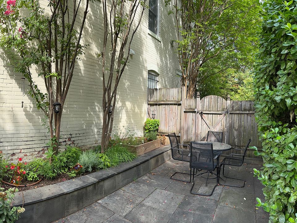 East view of patio with eating area and gardens.