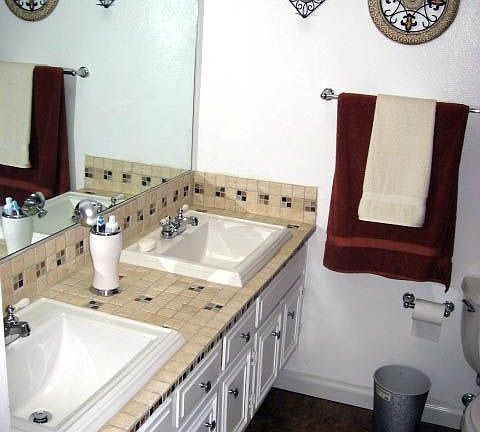 Travertine counters in upgraded bathrooms