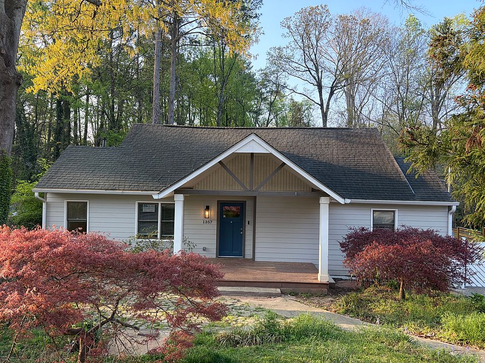 Street view of the house. Front porch with gate on the right side of the house.