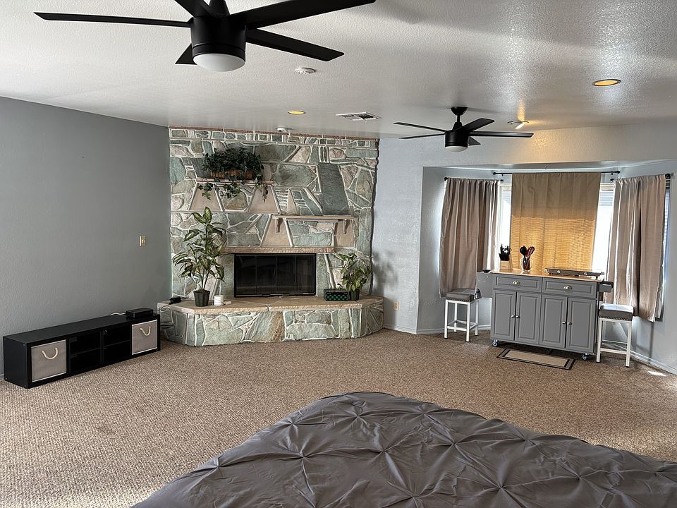 Looking from bed toward fireplace and dining area