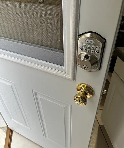 Private front door with keypad for secure entry. The window has a slide feature with a screen for breeze.