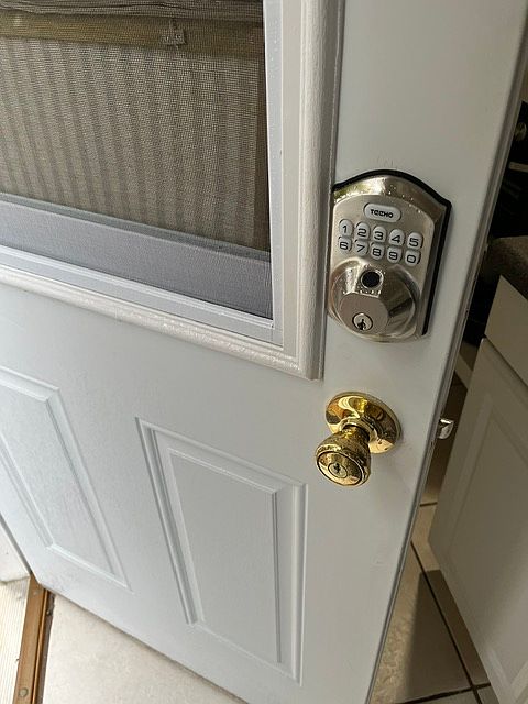 Private front door with keypad for secure entry. The window has a slide feature with a screen for breeze.