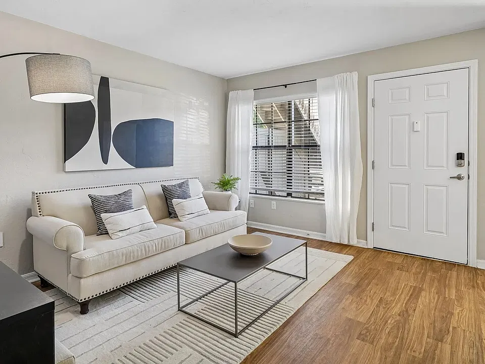 Relax and unwind in a bright, comfortable living room featuring wood-style flooring, abundant natural light, and a spacious, open layout.