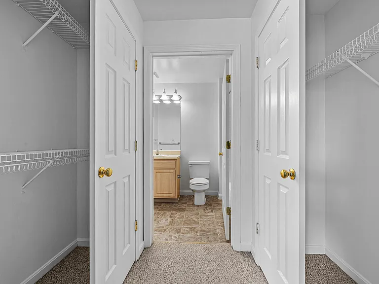 Carpeted Walk-In Closet to Bathroom Flow