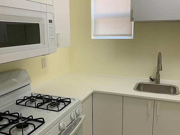 New Stove, Microwave, Cabinets, Tile floor, Sink