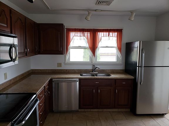 Kitchen view showing tile floor, granite counter tops, quality cabinets and quality appliances