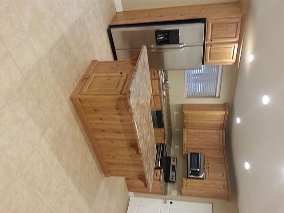 Kitchen with full island and SS appliances