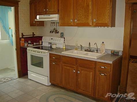 Kitchen with refrigerator and electric range oven
