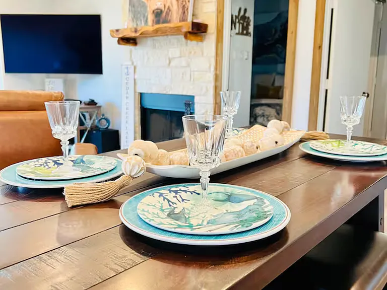 Stylish dining area with a high-top table for 4, plus 4 bar stools at the kitchen counter_perfect for casual meals and socializing.