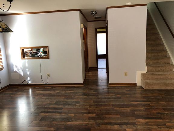 Front room with hallway leading back to the back room.