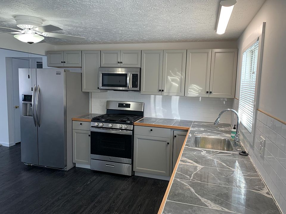 Kitchen with Gas range, disposal, dishwasher, Full sized fridge with water and ice through the door, and microwave