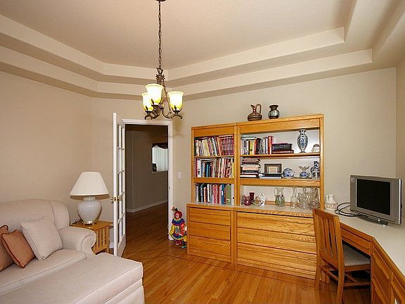 Office with hardwood flooring and coffered ceiling