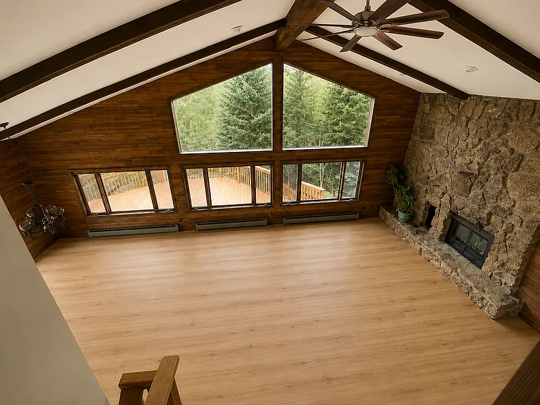 View of living room coming back down from main bedroom. Photo is digitally altered to show flooring and ceiling fan updates (original photos were taken prior to the floors and ceiling install).