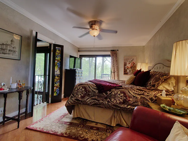 Primary bedroom with French doors opening up to large 2 story living room; Enjoy one of the most comforable king sized bed ever