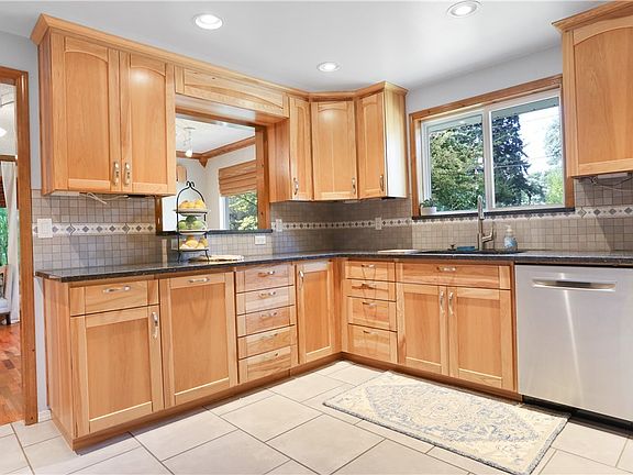 Perfectly placed pass-through window into the dining room for easy entertaining. Notice the tons of cabinet space this kitchen provides!