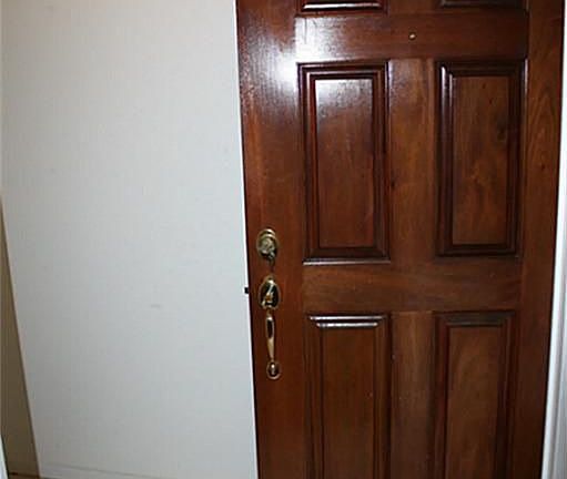 Solid wood door as you walk into the marble flooring of the entry.