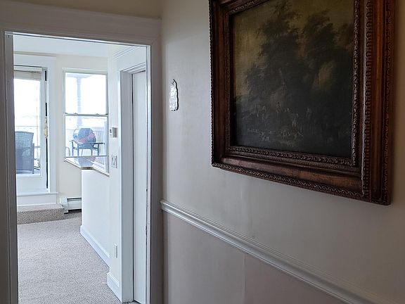 Entry - galley kitchen and bathroom on the right, open living room area on the left.