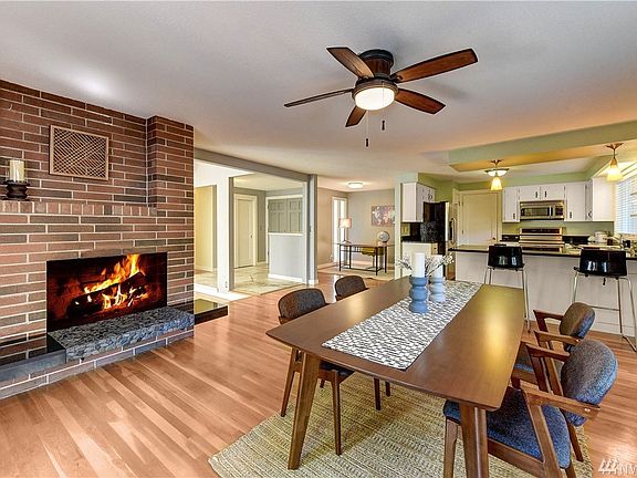 Open Design. Dining room with wood-burning fireplace. 