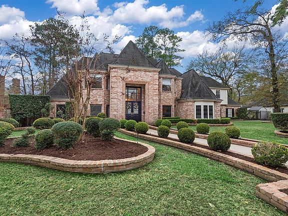 The manicured front lawn and mature landscaping add the perfect touch to the front of the home.