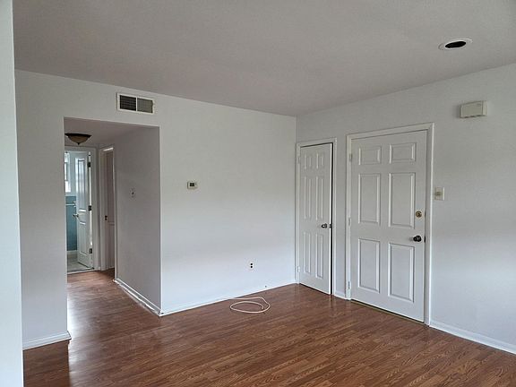Closet & Apt door - Hallway leading to bathroom & bedrooms