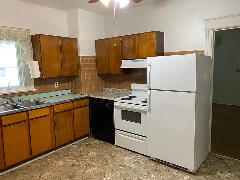 Table space Kitchen with double bowl sink, electric range, dishwasher, refrigerator, ceiling fan