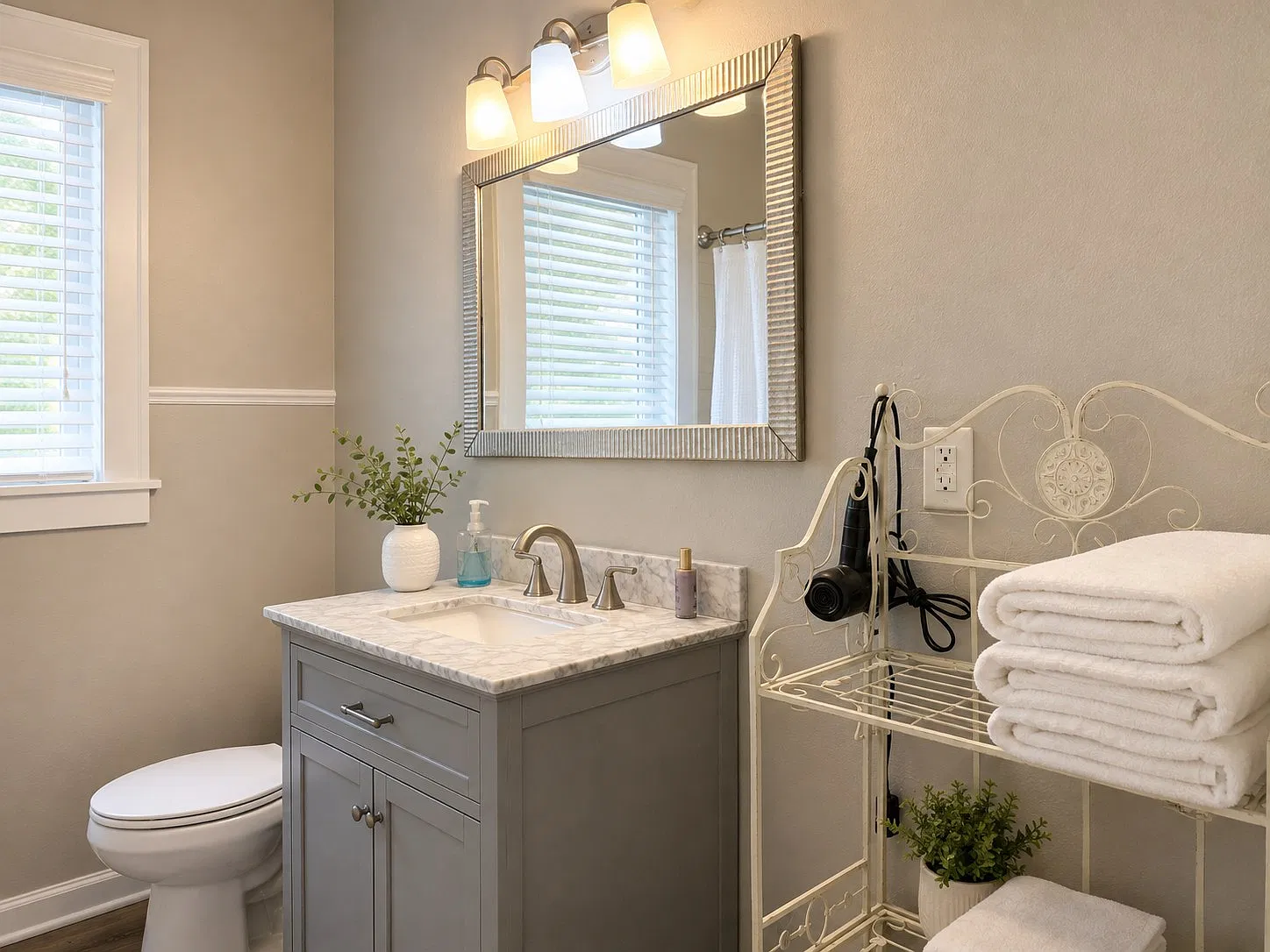 Bathroom with a marble vanity, fresh white towels and a hair dryer