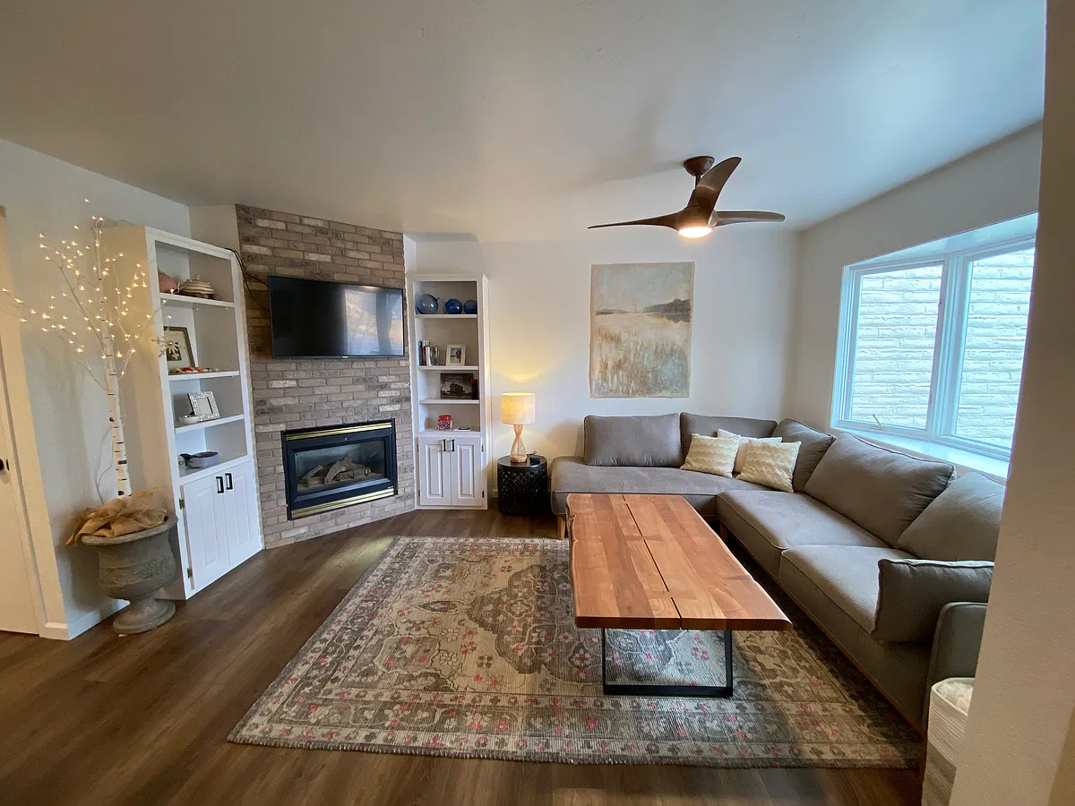 Living area with gas fireplace, ceiling fan, and bay window - 3 Hemlock Ct