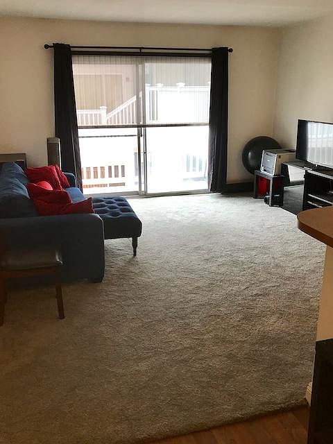 A large open living room with balcony access.