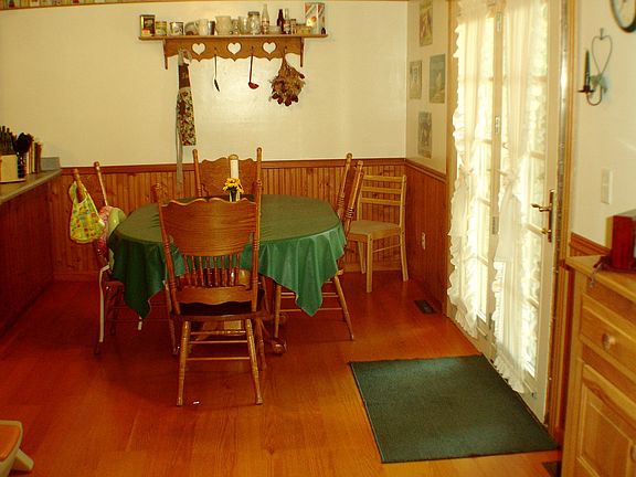 DR or eat in kitchen area off kitchen with pergo floor and patio door to patio