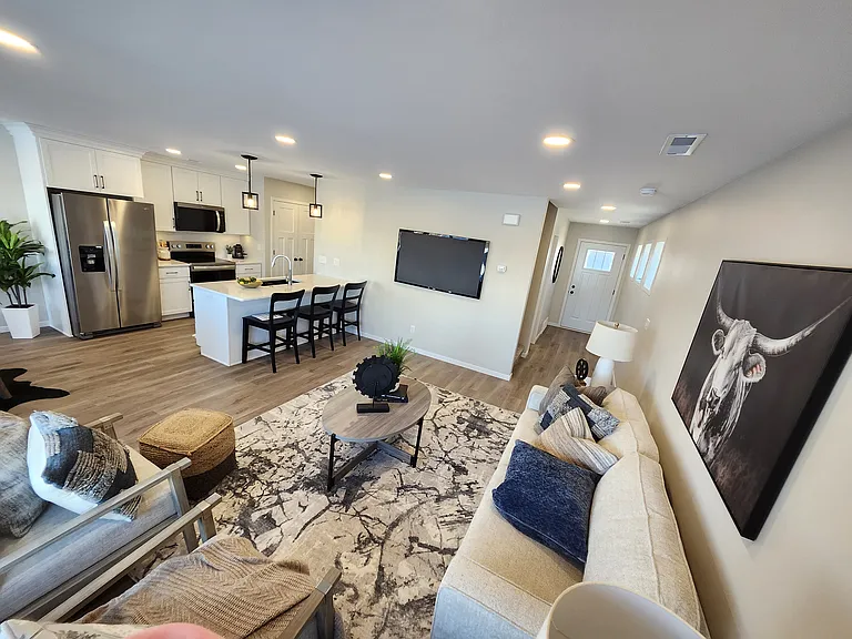 Beautiful living room open to kitchen and dining. (Pictures are of another unit with similar finishes and features.)