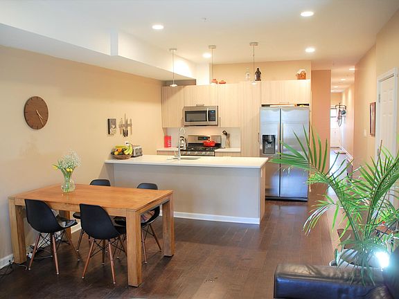 Staged view of living area and kitchen