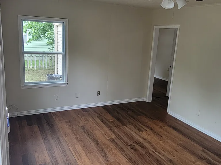 Living room doorway to kitchen and primary bedroom